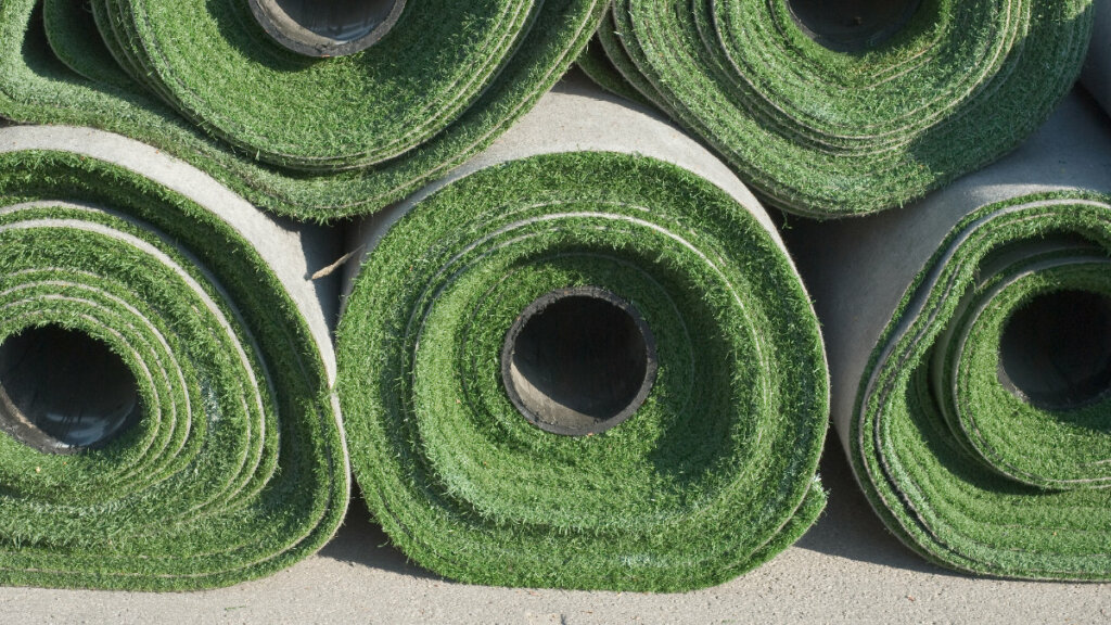 image of excess artificial turf from an installation project, showing neatly stacked rolls of high-quality synthetic grass