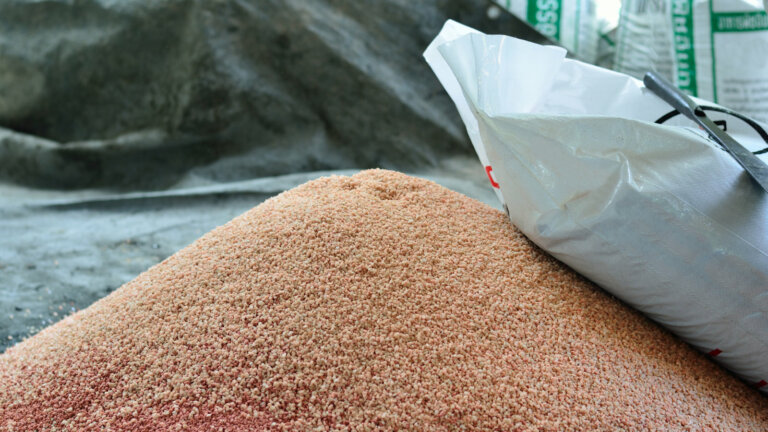 A heap of phosphorus fertilizer seeds, emphasizing the essential role phosphorus plays in promoting root development and overall plant health